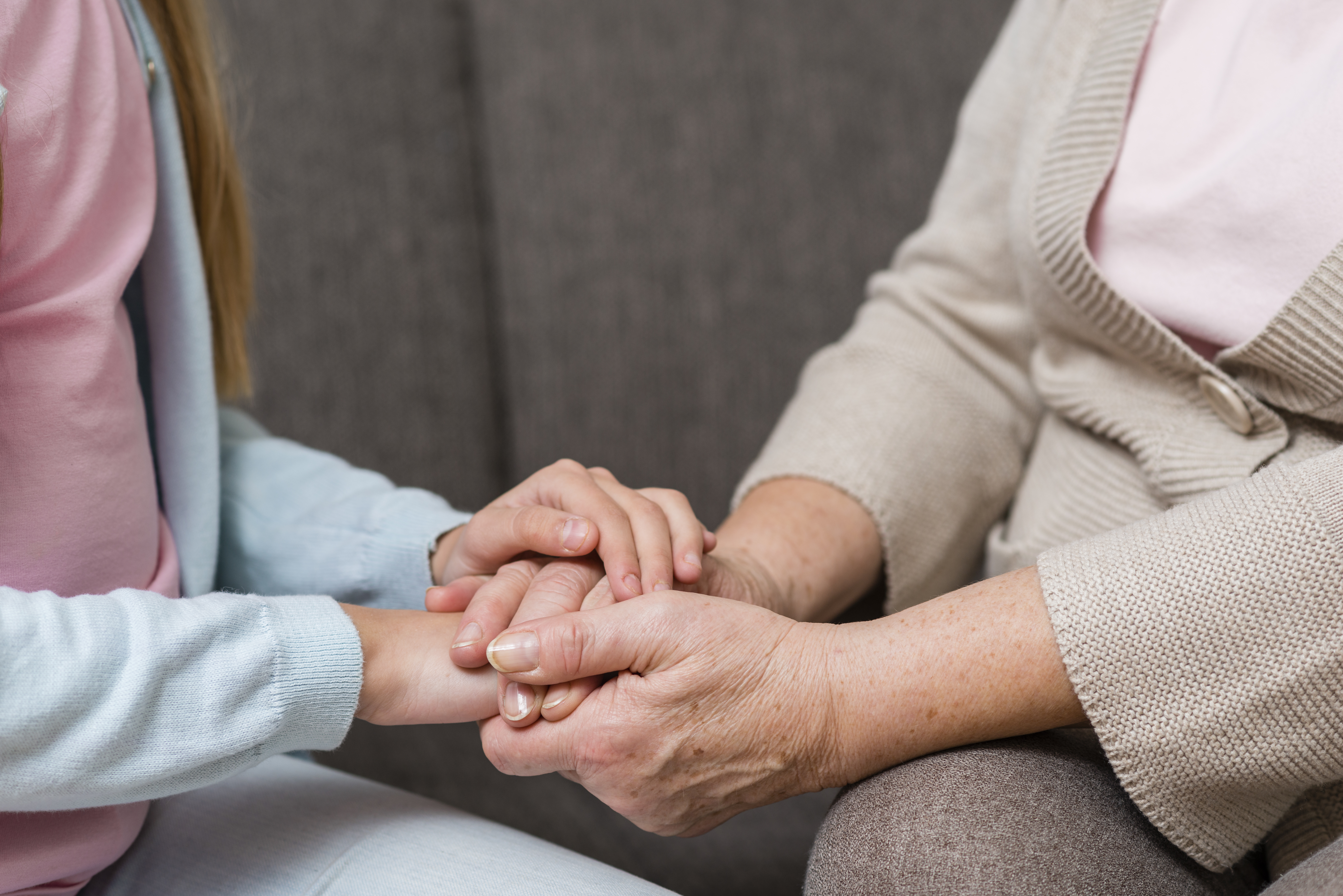 grandmother-granddaughter-holding-hands-close-up (1)